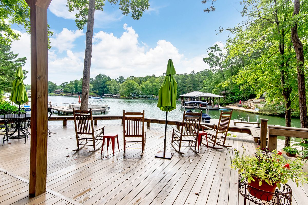 Rocking chairs on a lakeside porch looking out over Lake Martin